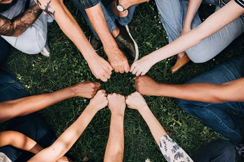 diverse-community-with-hands-circle